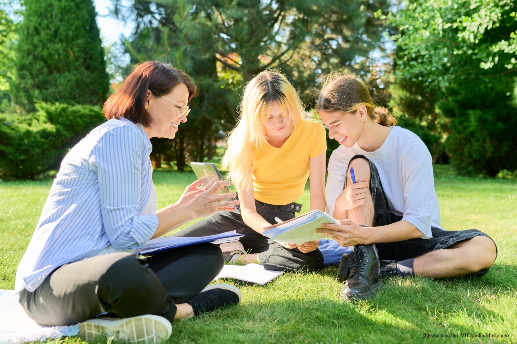 Teenagers with an adult outside 