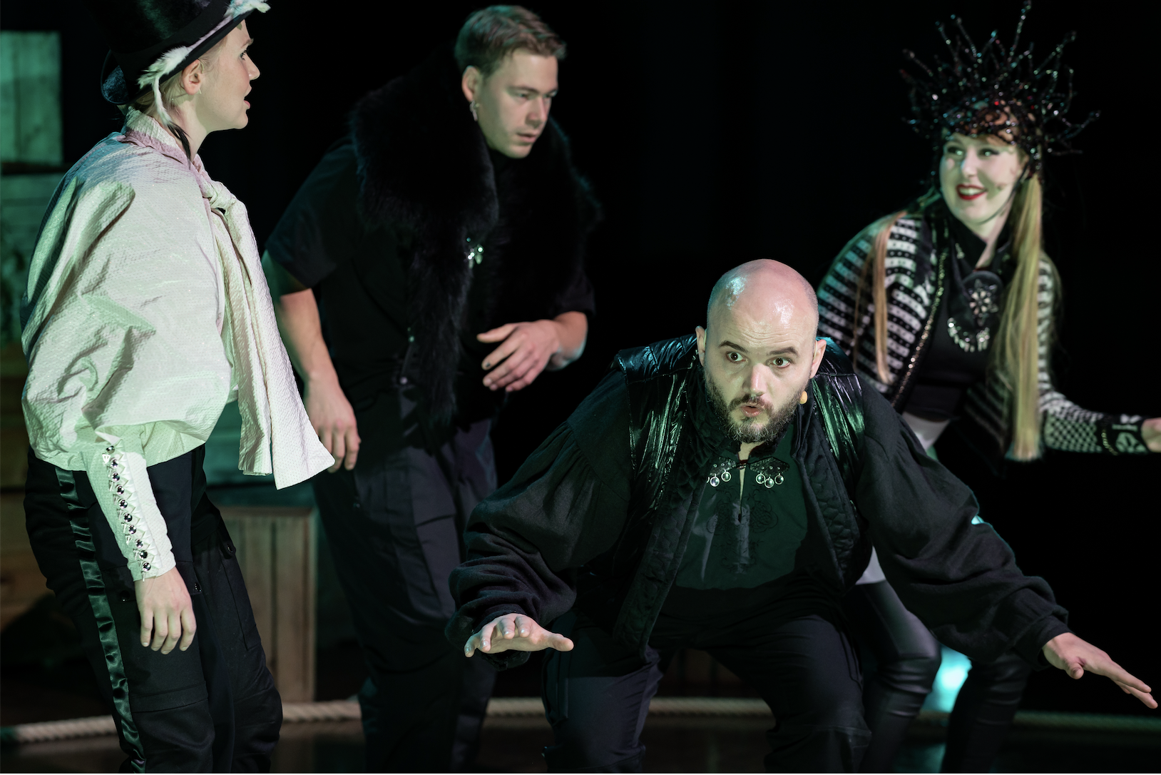 Four actors in action during the theatre production 'Näkymätön kansa'
